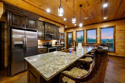 Expansive kitchen island with farmhouse sink.
