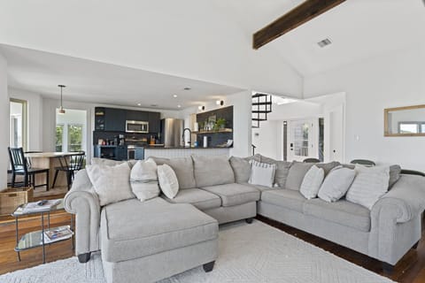 Unwind on our spacious sectional couch, with the kitchen within easy reach.