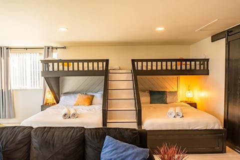 Signature bunk room — 2 Queens, 2 Twin lofts & cozy sectional (sleeps 6)