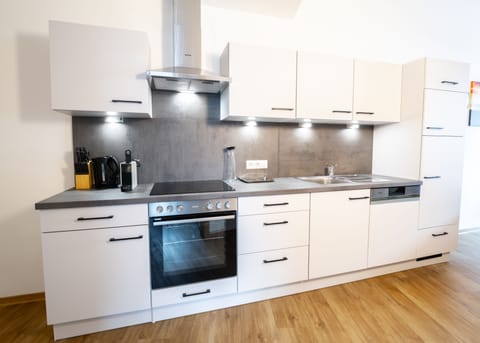 Deluxe Apartment, 3 Bedrooms | Private kitchen | Full-size fridge, microwave, oven, stovetop