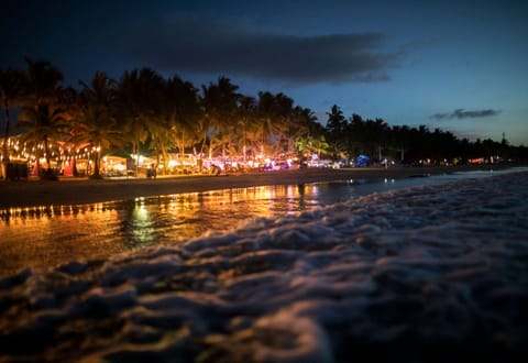 On the beach, white sand, sun loungers, beach towels