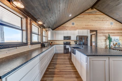View looking left from the entry door down the length of the kitchen.