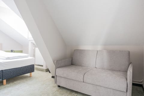 Deluxe Quadruple Room | Down comforters, in-room safe, desk, iron/ironing board