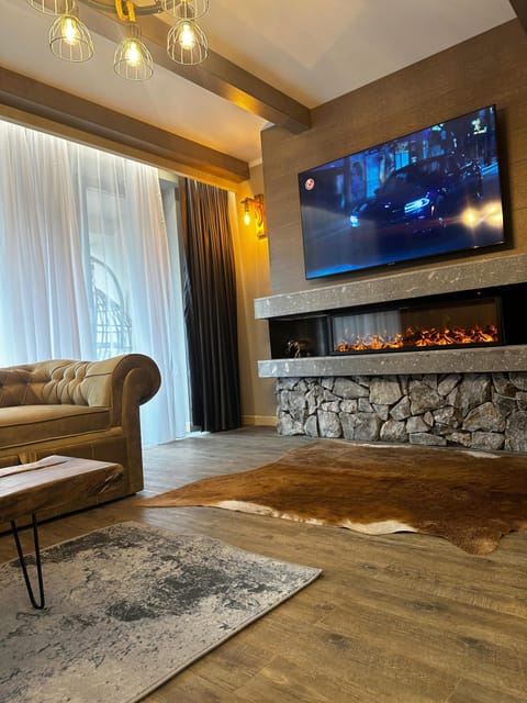 Deluxe Chalet | Living area | 120-cm Smart TV with digital channels, fireplace