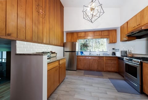 Main House - Fully stocked kitchen looking into the Dining Space