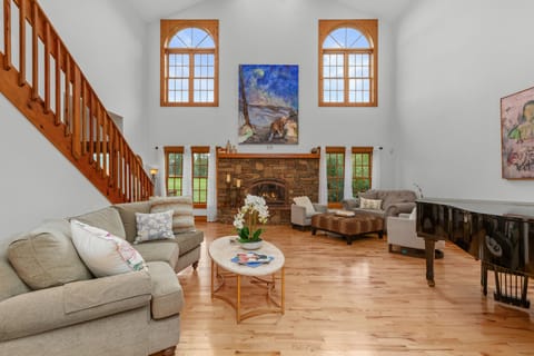 The living room has a gas fireplace (seasonal). (Piano covered & not available)