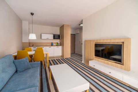 Living room with television and sofa.