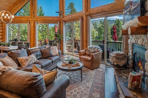 Luxury log waterfront home with views, deck and fireplace
