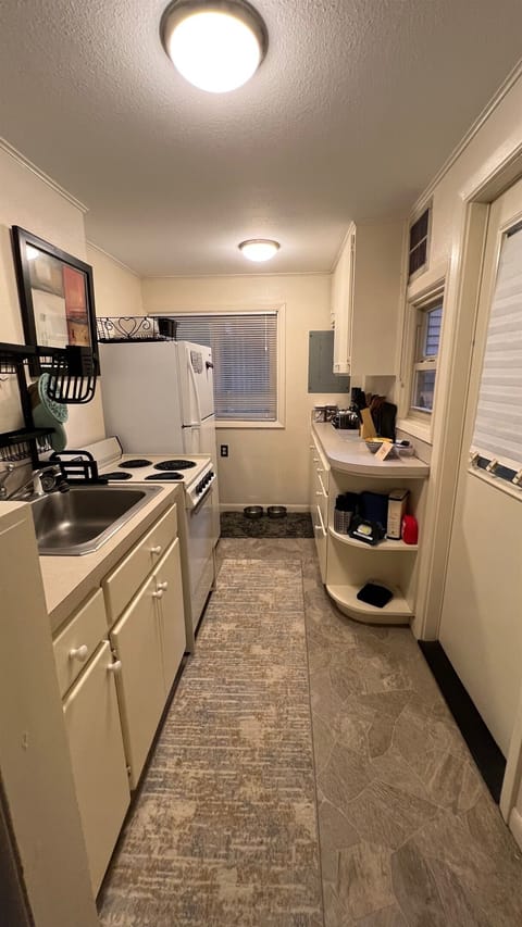 Kitchen, with full, four burner stove and oven, full-sized refrigerator/freezer and a wide selection of cookware.