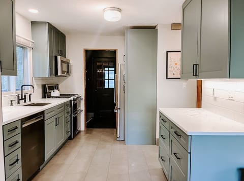 Kitchen and hallway to full bath and Bedroom 1 off to the right