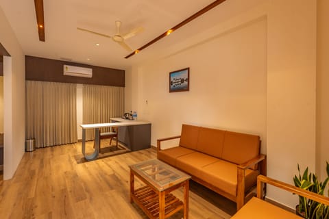 Premium Studio Suite | Living area | 32-inch Smart TV with satellite channels