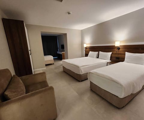 Standard Suite, Multiple Beds, Private Bathroom, Garden View | Premium bedding, minibar, in-room safe, blackout drapes