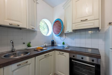 Family Apartment, 2 Bedrooms, Sea Facing (La Casina Del Pescatore On the Beach) | Private kitchen | Fridge, oven, stovetop, coffee/tea maker