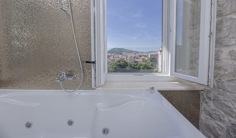 Deluxe Double or Twin Room, Partial Sea View | Bathroom | Combined shower/tub, jetted tub, free toiletries, hair dryer