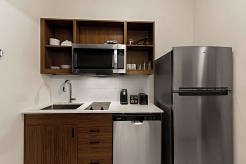 Full-size fridge, microwave, cookware/dishes/utensils, paper towels