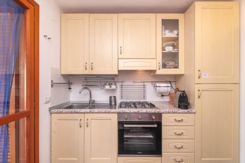 Family Apartment, 1 Bedroom (Giotto In Sardegna With Shared Pool) | Private kitchenette | Stovetop, coffee/tea maker, cookware/dishes/utensils