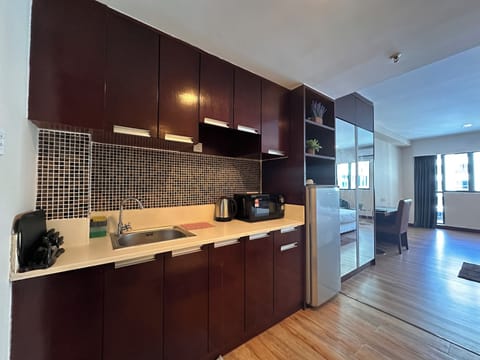 Standard Apartment (Orchid) | Private kitchen | Full-size fridge, electric kettle, cookware/dishes/utensils