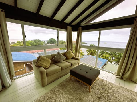 Honeymoon Suite, Ocean View | Living area | 32-inch flat-screen TV with cable channels