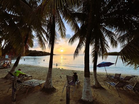 On the beach, white sand, sun loungers, beach umbrellas