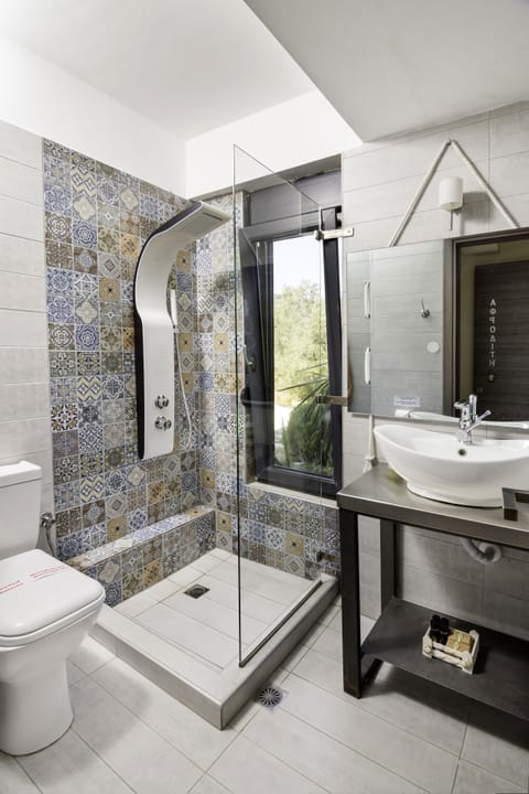 Junior Suite, Sea View | Bathroom | Shower, designer toiletries, hair dryer, bathrobes