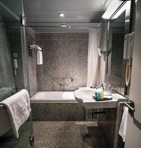 Separate tub and shower, hair dryer, slippers, towels