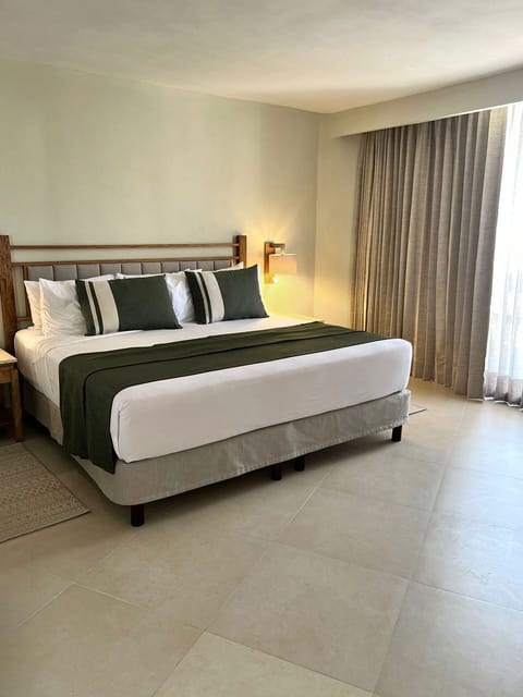 Deluxe Room, Pool View | In-room safe, desk, blackout drapes, iron/ironing board