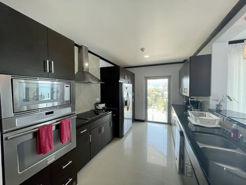 Condo, 4 Bedrooms | Private kitchen | Fridge, coffee/tea maker, toaster