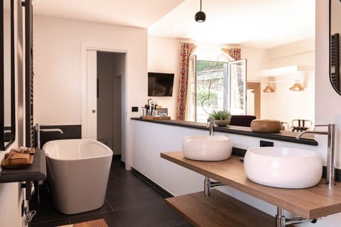 Suite, 1 Bedroom | Bathroom | Rainfall showerhead, hair dryer, bathrobes, slippers