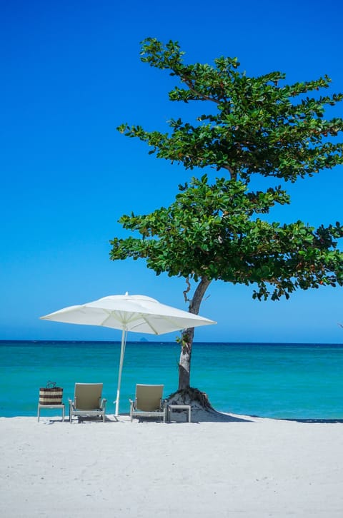 Private beach, white sand, sun loungers, beach umbrellas