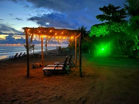 On the beach, black sand, free beach cabanas, sun loungers