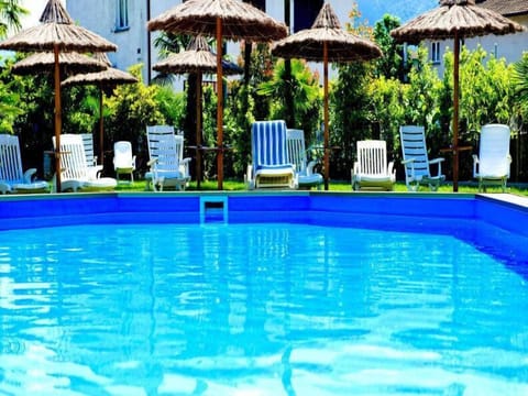 Seasonal outdoor pool, open 10:00 AM to 6:00 PM, pool umbrellas