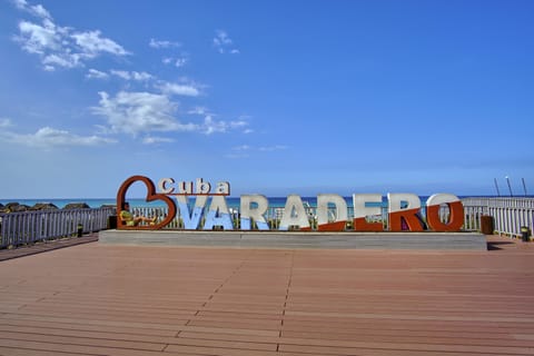 On the beach, white sand, beach cabanas, sun loungers