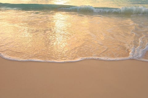 On the beach, white sand, sun loungers, beach umbrellas