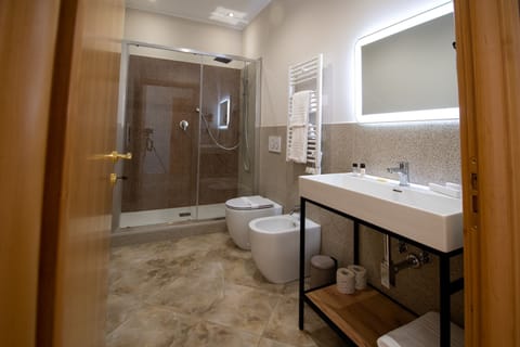 Junior Double Room, Balcony, City View | Bathroom | Shower, hair dryer, slippers, bidet