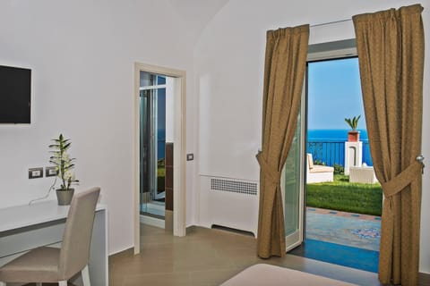 Superior Double Room, Terrace, Sea View | Minibar, in-room safe, desk, laptop workspace