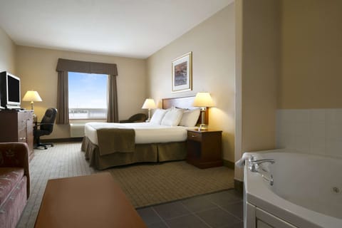 Suite, 1 King Bed, Non Smoking, Jetted Tub | Desk, laptop workspace, blackout drapes, iron/ironing board