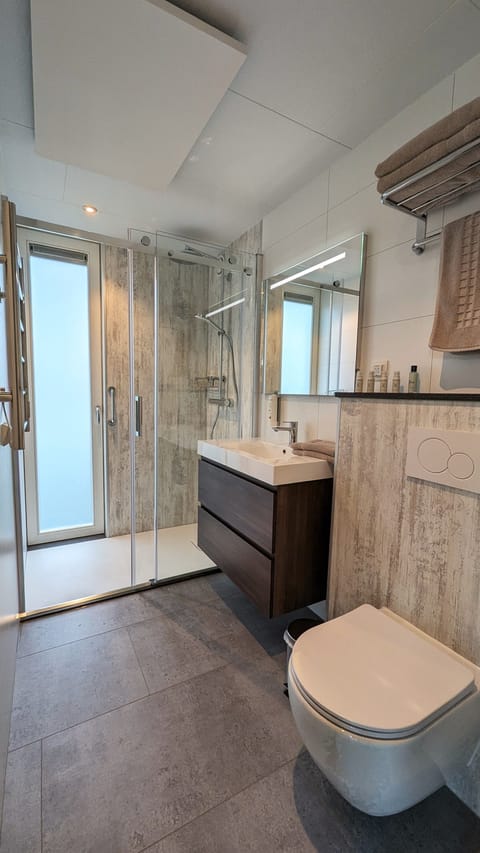 Shower, rainfall showerhead, hair dryer, towels