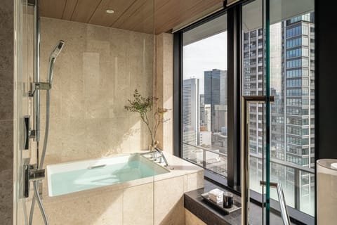 Suite, 1 King Bed, Corner (Four Seasons) | Bathroom | Separate tub and shower, rainfall showerhead, designer toiletries