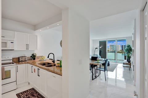 Gallery Condo | Private kitchen | Full-size fridge, microwave, oven, stovetop