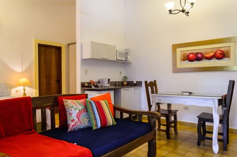 Deluxe Apartment, 1 King Bed, Pool View, Garden Area | Minibar, in-room safe, individually decorated, individually furnished