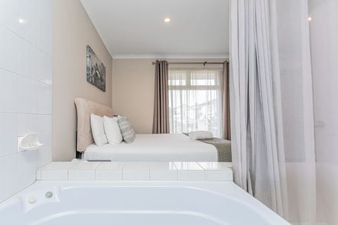 Executive Suite, 1 King Bed, Jetted Tub, Ground Floor | Premium bedding, desk, iron/ironing board, cribs/infant beds