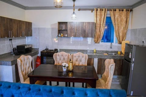 Comfort Apartment | Private kitchen | Fridge, microwave, cookware/dishes/utensils, dining tables