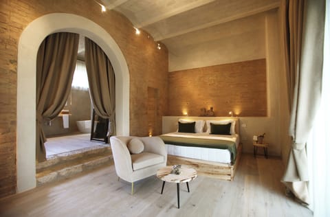 Deluxe Room, Patio, Garden View | Minibar, in-room safe, desk, laptop workspace