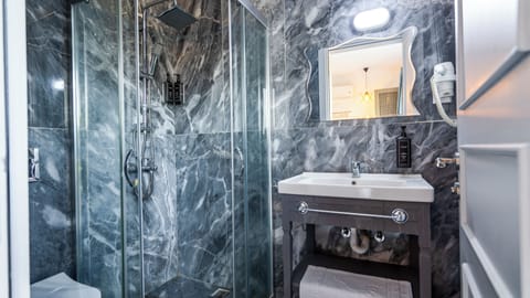 Shower, hair dryer, slippers, towels