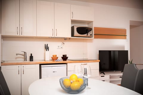 Comfort Apartment, Beachfront | Private kitchen | Mini-fridge, highchair, cookware/dishes/utensils