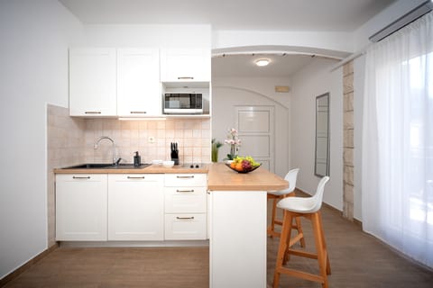 Classic Studio, Balcony, Beachfront | Private kitchen | Mini-fridge, highchair, cookware/dishes/utensils