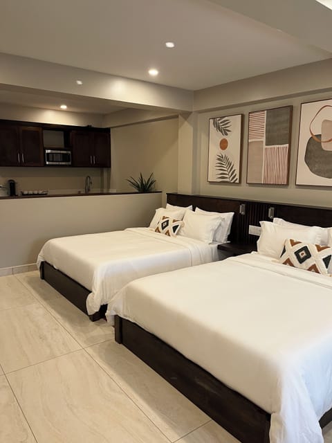 Deluxe Suite, 2 Bedrooms, Pool View | Minibar, in-room safe, desk, laptop workspace