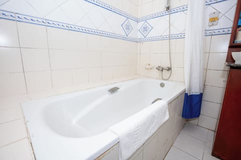 Executive Suite, Balcony, Beach View | Bathroom | Combined shower/tub, slippers, towels, soap