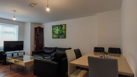 Apartment, Garden View | Living area | Flat-screen TV