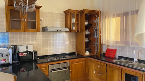 Elite Apartment | Private kitchen | Fridge, cookware/dishes/utensils, dining tables